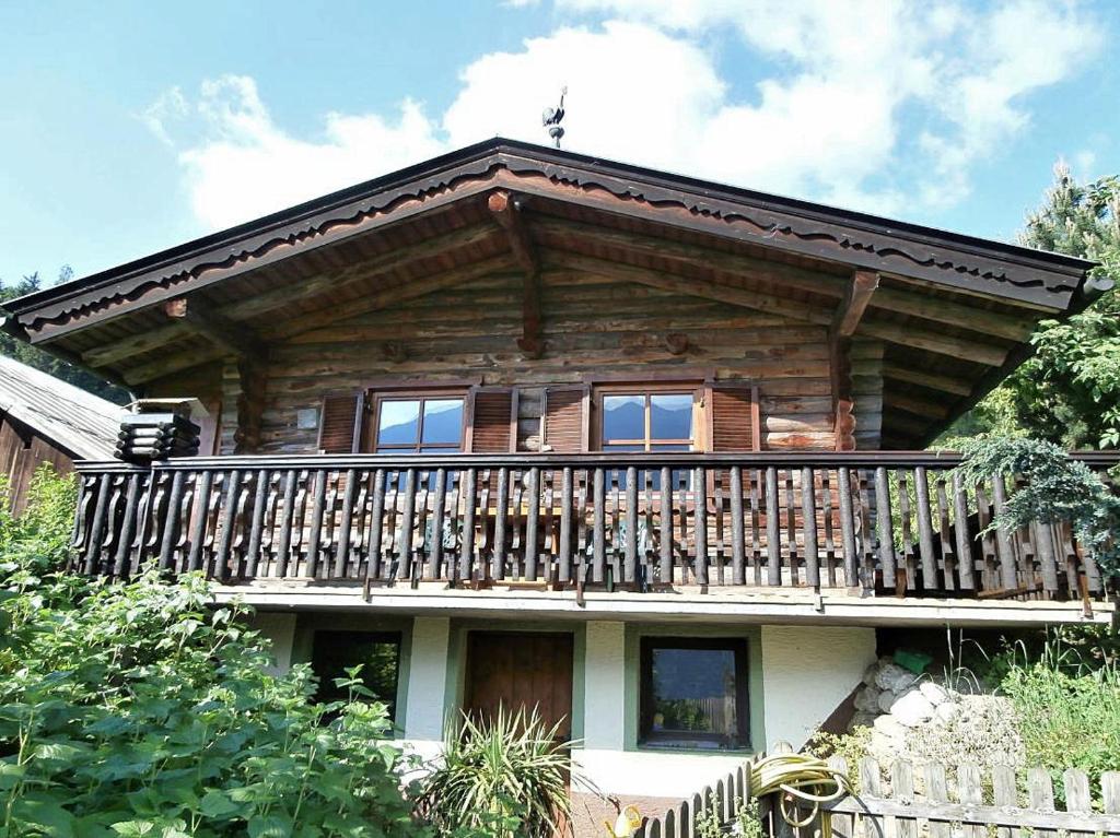 a log cabin with a balcony on top of it at Almliesl GAST-462 in Bad Hofgastein