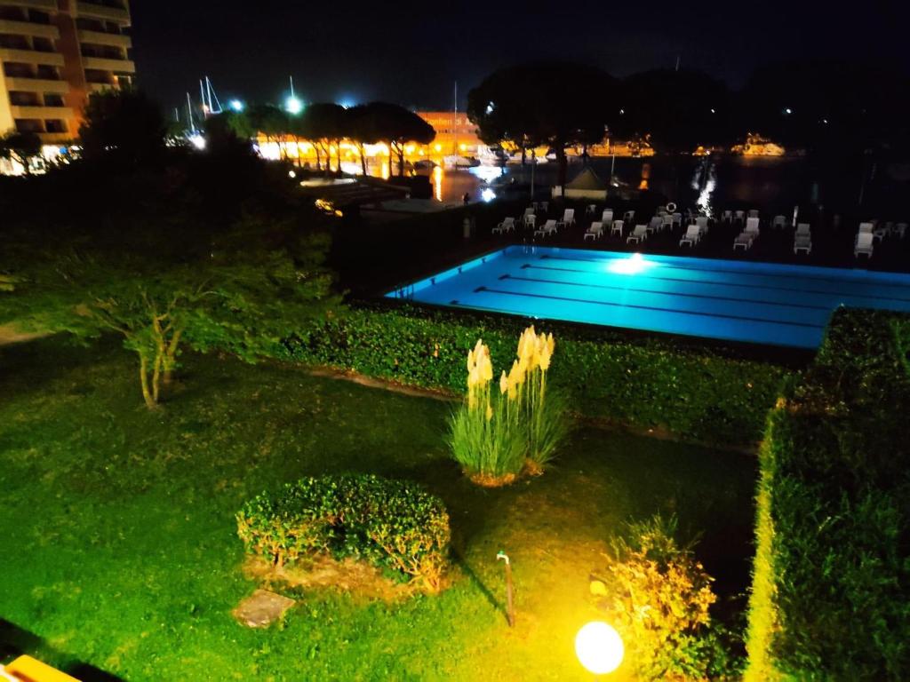 a view of a swimming pool at night at Signora Ruth - Aprilia Residence in Aprilia Marittima