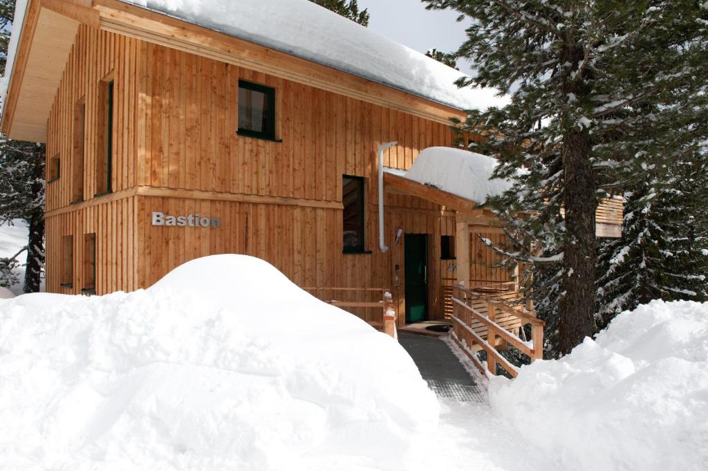 a log cabin with a pile of snow in front of it at Chalet Bastion in Brandstätter