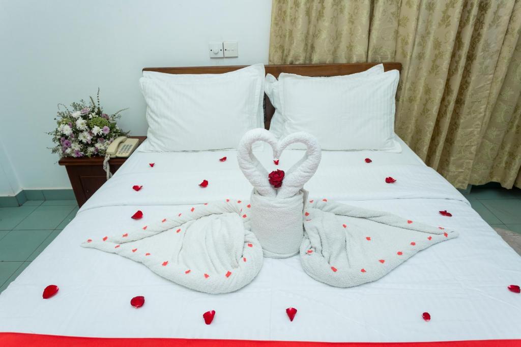 a bed with two swans made to look like hearts at The Ocean Pearl Resorts in Panadura