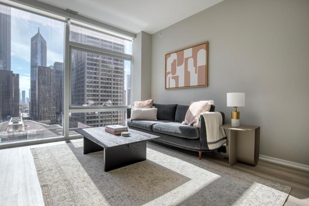a living room with a couch and a large window at Streeterville 1br w terrace gym nr riverwalk CHI-997 in Chicago