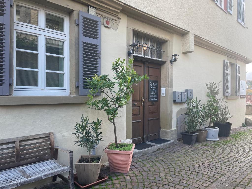 un edificio con una puerta y un banco delante de él en Gästezimmer an der Stadtmauer en Besigheim