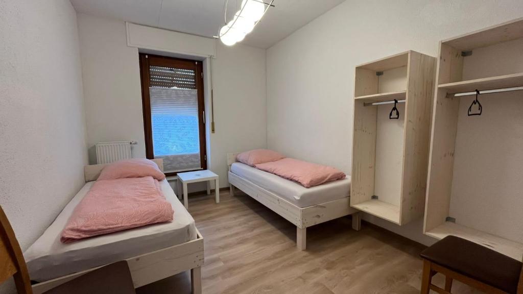 a room with two beds and a window at Highway Ferienwohnung in Preußisch Oldendorf