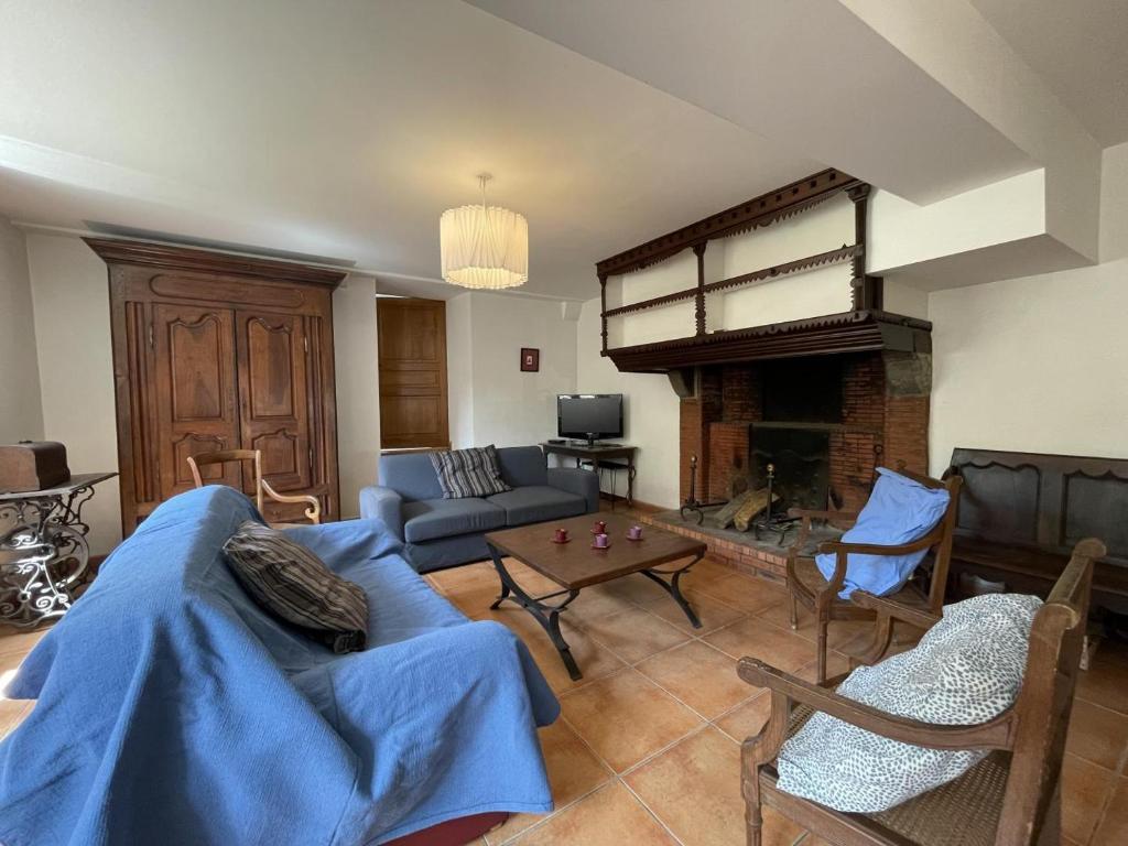 a living room with a couch and a fireplace at Saint marty in Montory