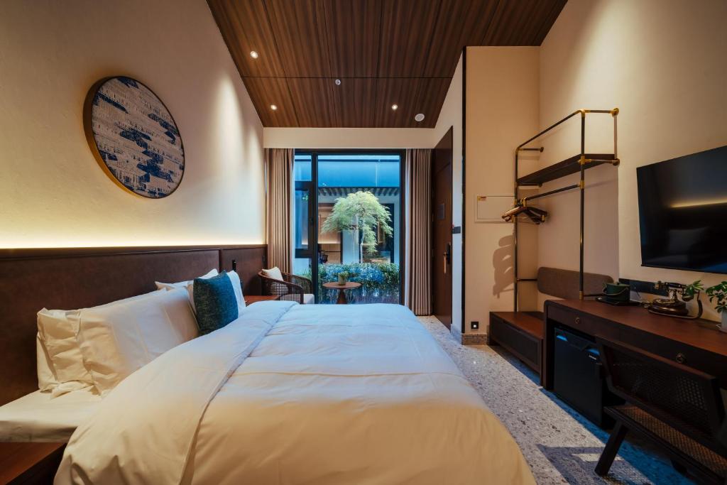 a bedroom with a large bed and a television at Jingmao Alley Hotel - Beijing Wangfujing Dongsi Subway Station Branch in Beijing