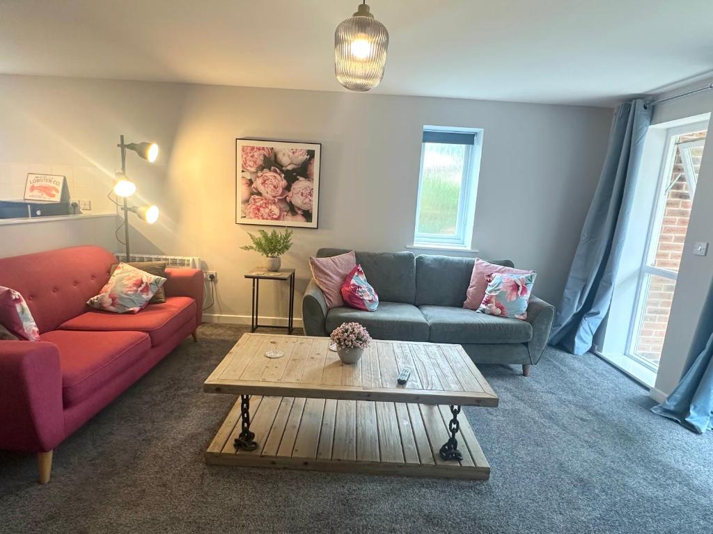a living room with two couches and a coffee table at Superb 2 bed 2 bathroom free parking in Derby