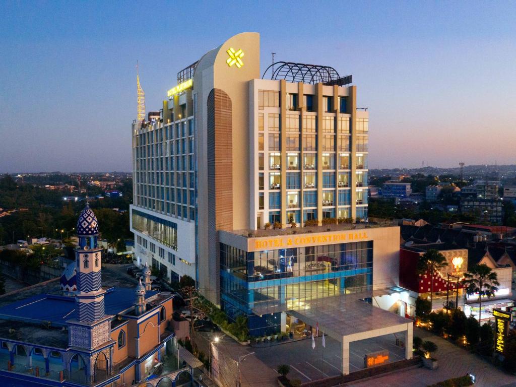 a large building with a clock on top of it at Platinum Hotel & Convention Hall Balikpapan in Balikpapan