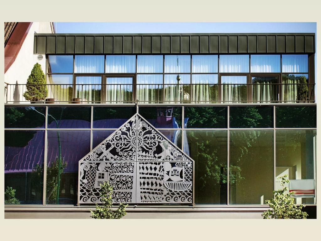 a building with a large window with a design on it at Linden Home Klaipeda Centrum Apartment in Klaipėda