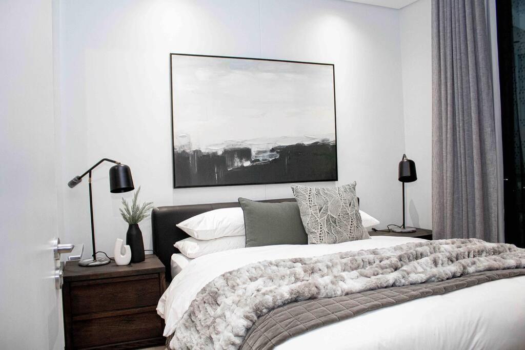 a bedroom with a bed and a painting on the wall at Epic Getaway in Waterfall in Midrand