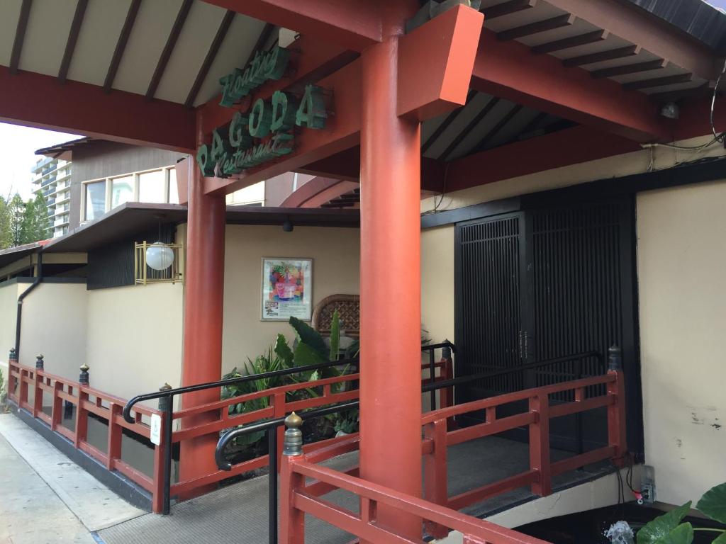 a restaurant with red columns on a building at Pagoda Hotel in Honolulu