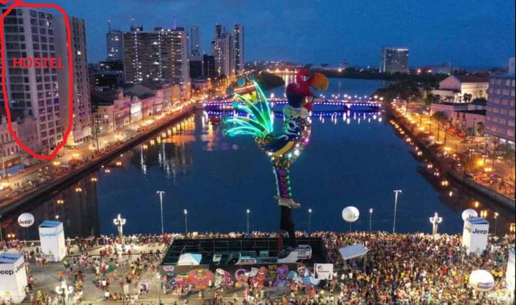 a large crowd of people standing near a river at night at Melhor localização Recife até 8 pessoas in Recife