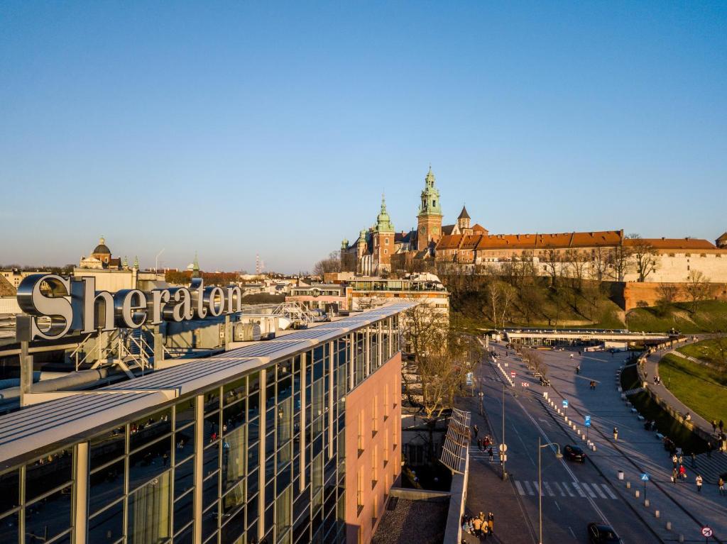 a view of a city with a building and a street at Sheraton Grand Krakow in Kraków