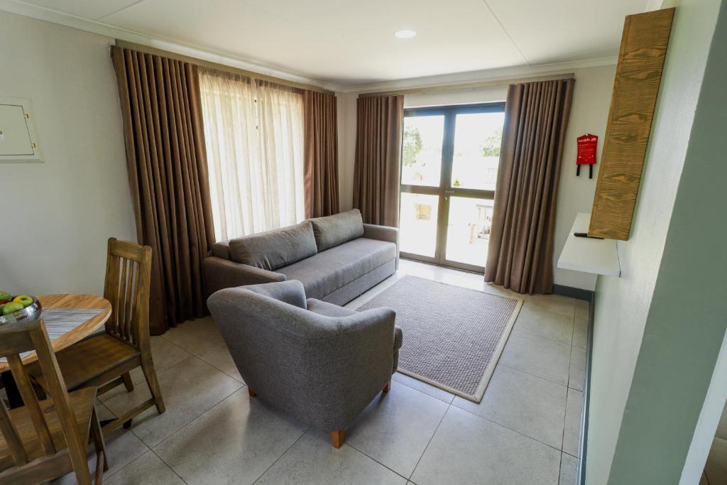 a living room with a couch and a table at Emerald Resort & Casino in Vanderbijlpark