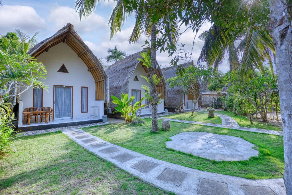 a villa with a garden and a church at Ananta Bungalow in Nusa Penida