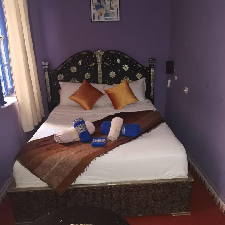 Postel nebo postele na pokoji v ubytování RIAD DAR LFONOUN