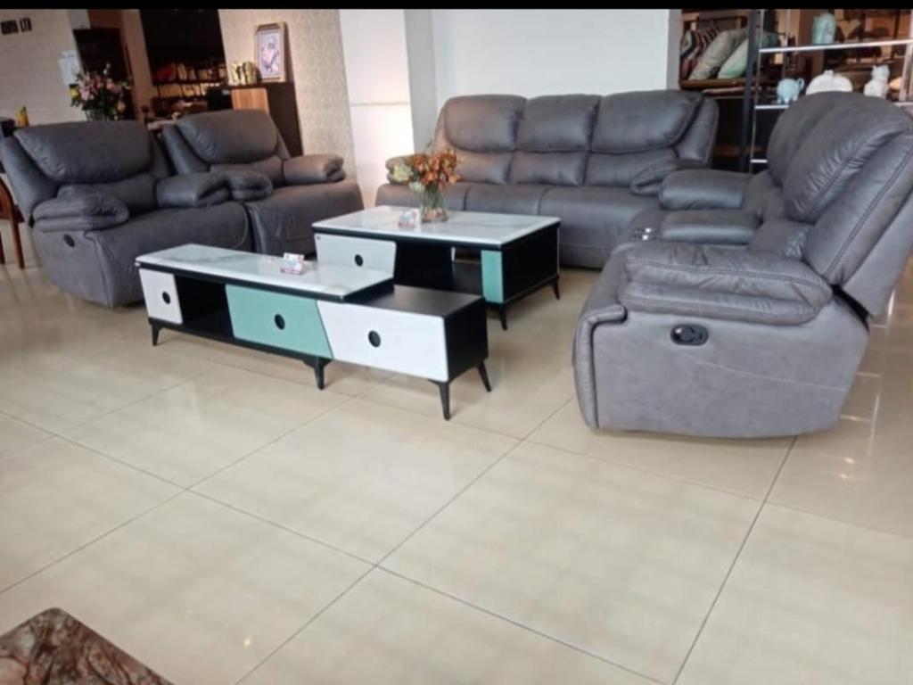 a living room with a couch and two tables at The place rich in Nairobi