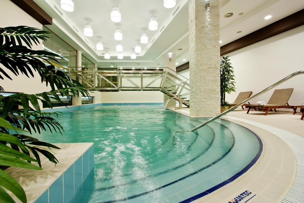 a swimming pool in a building with a bridge at Earth & People Hotel & SPA - Free Parking in Sofia