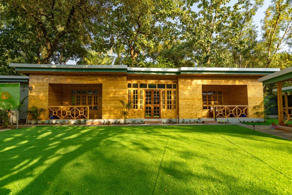 a house with a large lawn in front of it at Oxygen Palolem in Palolem