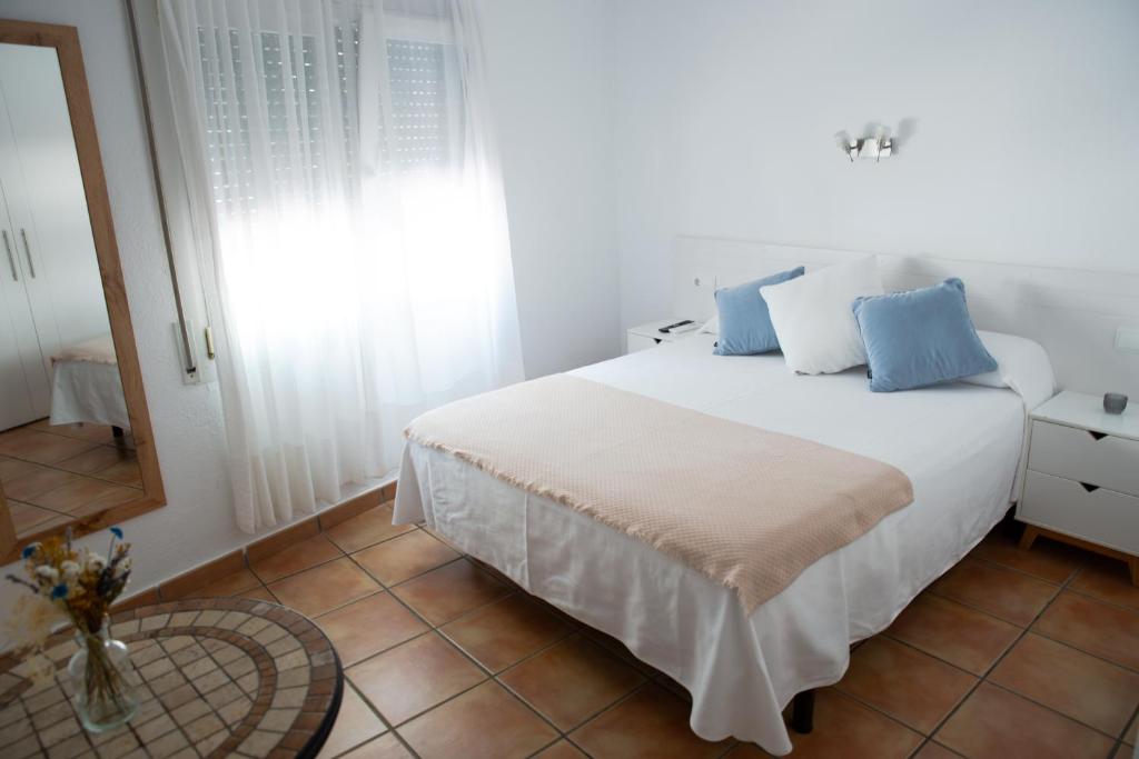 Postel nebo postele na pokoji v ubytování Hostal el Ranxo