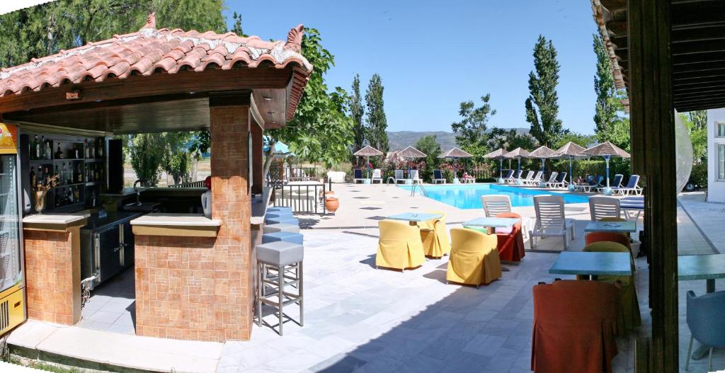 a resort with a bar next to a swimming pool at AEGEON in Kalloni