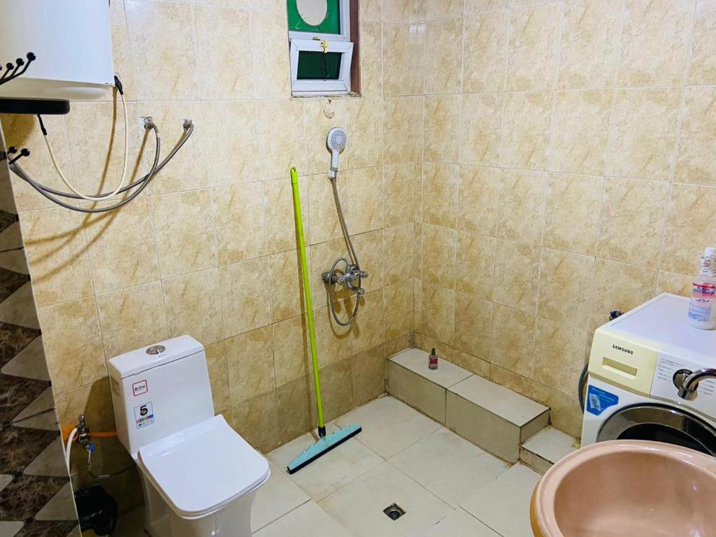 a bathroom with a toilet and a sink at Jerash sky1 in Jerash