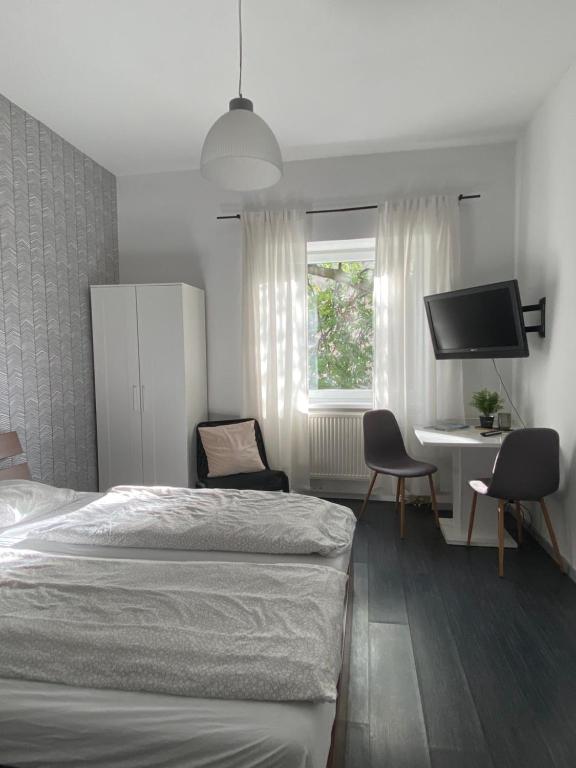 a bedroom with a bed and a desk and a tv at W28 / Beethoven room in Piešťany
