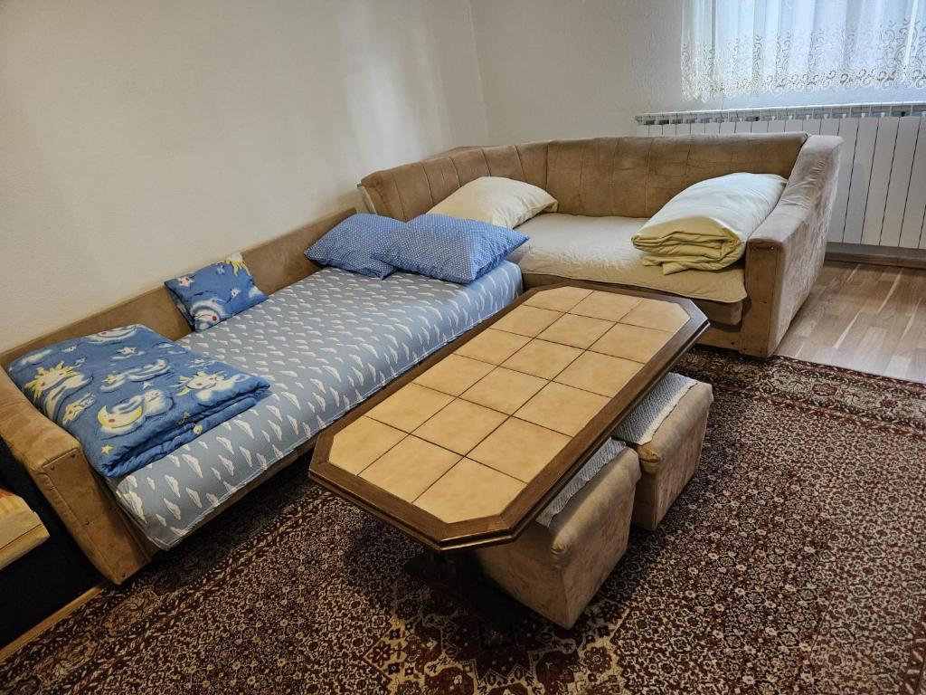 a couch and a table in a living room at سراييفو Sarajevo apartment in Sarajevo