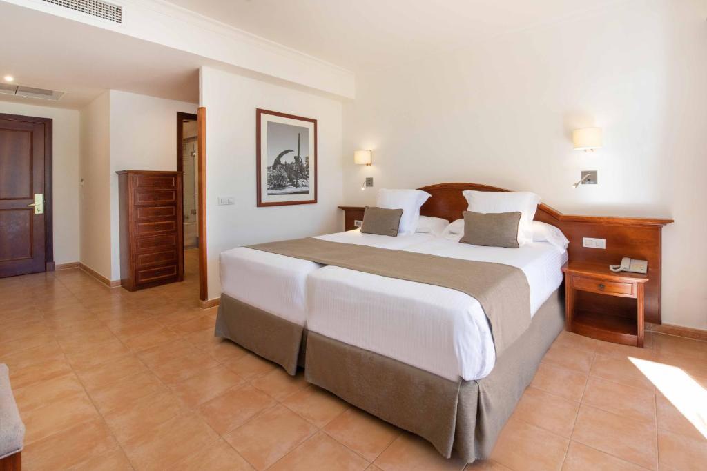 a bedroom with a large bed in a room at Valentin Sancti Petri in Chiclana de la Frontera