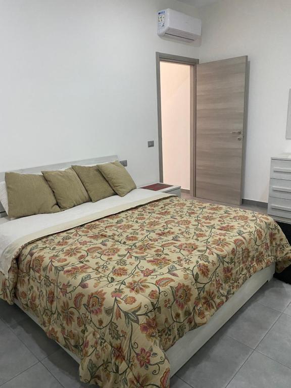 - une chambre dotée d'un grand lit avec un couvre-lit floral dans l'établissement Casa engy, à Riese
