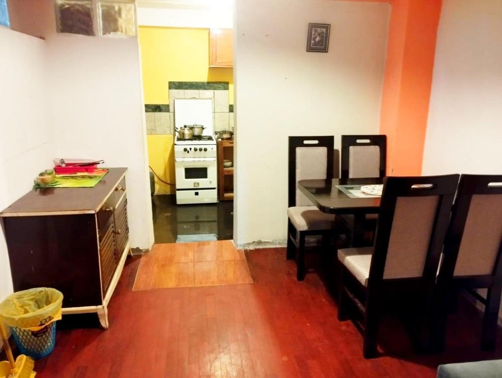 a kitchen and dining room with a table and a stove at Cruz Apartments - Centro Histórico de Cusco in Cusco