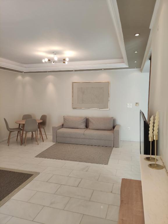 a living room with a couch and a table at TERRA LUXURY HOME in Drama
