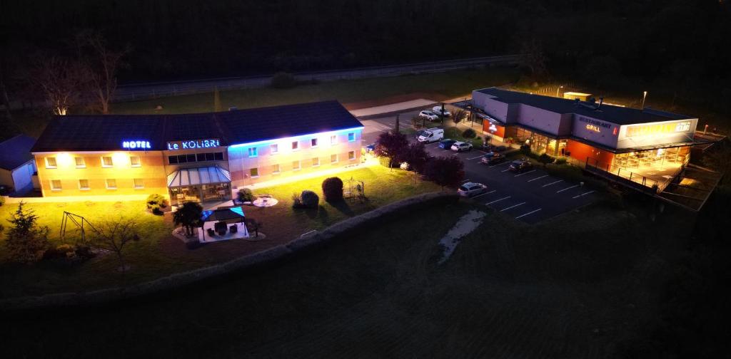an aerial view of a building at night at Hôtel Le Kolibri in Tournus