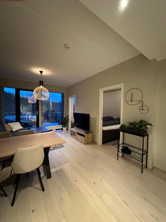a living room with a dining table and a television at Penthouse, Lerkendal, NTNU, free parking in Trondheim