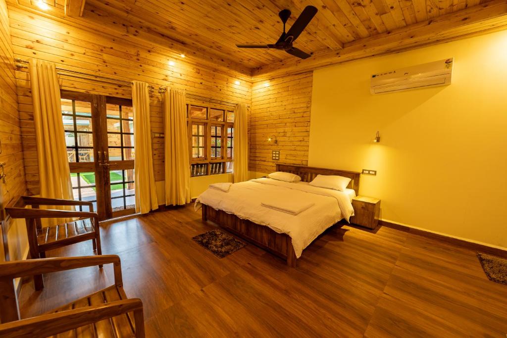 a bedroom with a bed and a ceiling fan at Oxygen Palolem in Palolem