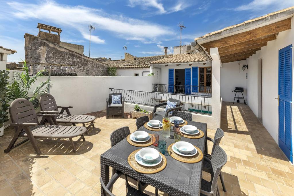a patio with a table and chairs on a balcony at Duplex flat in the old town of Alcudia in Alcudia