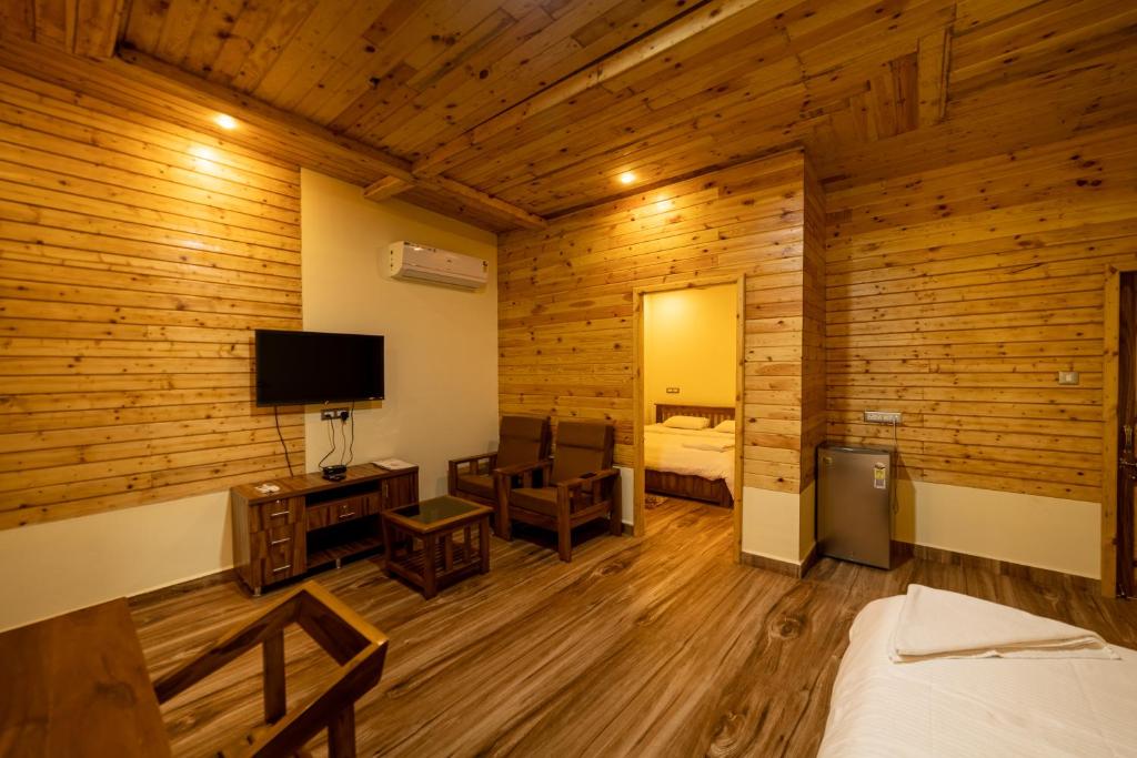 a room with a bed and a television in it at Oxygen Palolem in Palolem