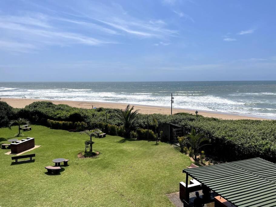 a view of a beach with a picnic table and the ocean at Unit 604 Shoreline in Freeland Park