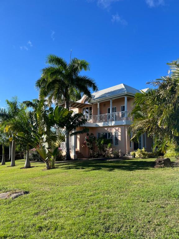 a large house with palm trees in front of it at Royal Palm Villas 