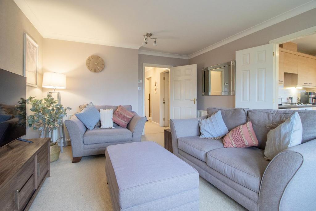 a living room with two couches and a table at Garden View Nook-2 bed apartment in High Blantyre