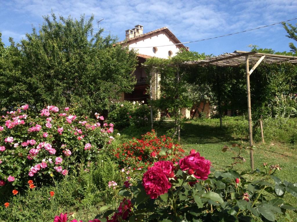 a garden with flowers in front of a house at Casa Isabella in Vaglio Serra