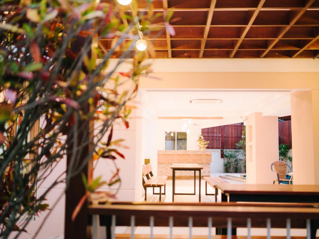 a dining room and kitchen with a table and chairs at Rendezvous Classic House in Chiang Mai