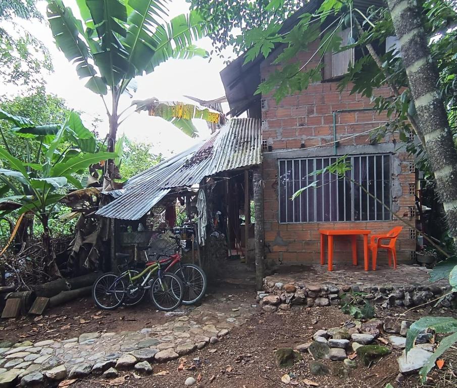 a house with two bikes parked in front of it at Morada Al Sur in Mocoa