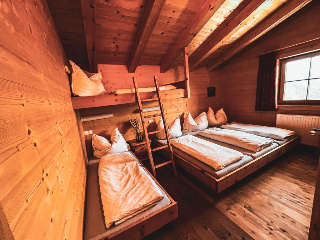 a room with two bunk beds in a cabin at Die Acherberg Alm in Oetz