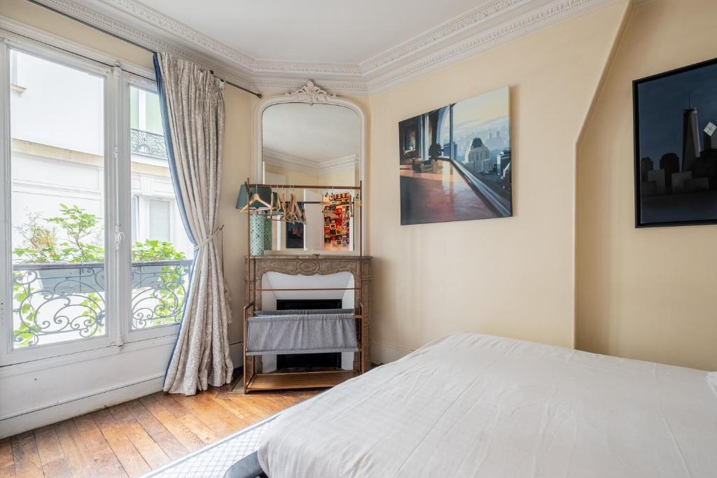 une chambre avec un lit et une grande fenêtre dans l'établissement Veeve - Sunrise Synergy, à Paris