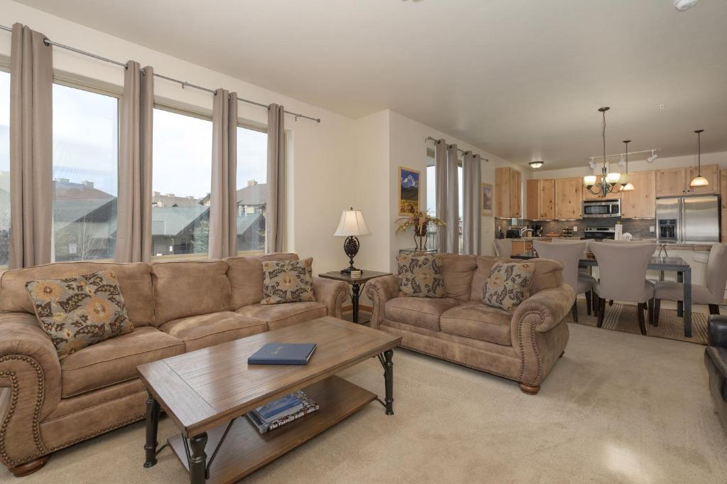 a living room with two couches and a table at Trailhead Lodges Building 401 Unit 422 in Winter Park
