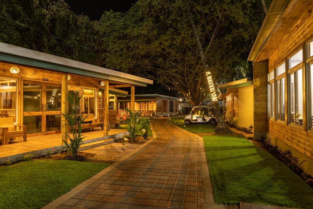 a house with a brick walkway next to a building at Oxygen Palolem in Palolem