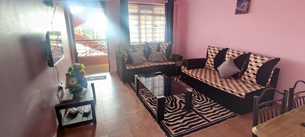a living room with a zebra print couch and chairs at Airbnb in Mwea town 