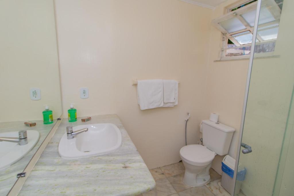 a bathroom with a sink and a toilet at Pousada Estrela do Mar in Salvador