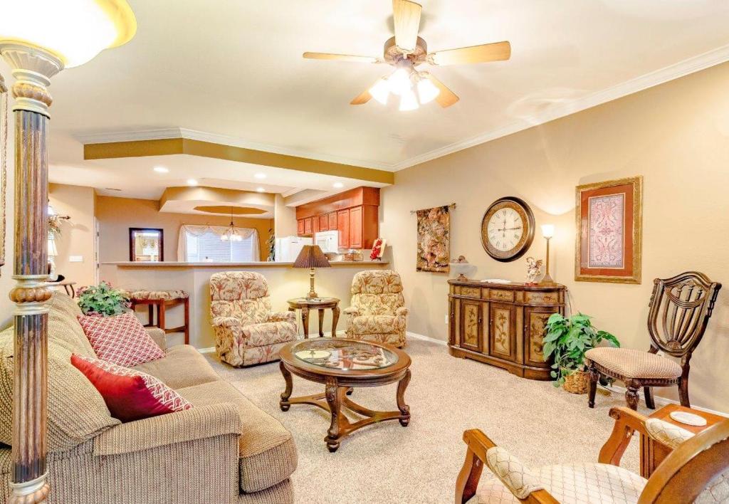 a living room filled with furniture and a ceiling fan at Branson Condo at Thousand Hills Walkin with Elevator Golf Front near 76 Strip in Branson