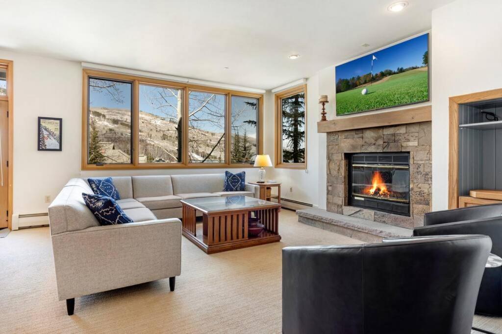 a living room with a couch and a fireplace at Beaver Creek Highlands Lodge 209 in Beaver Creek